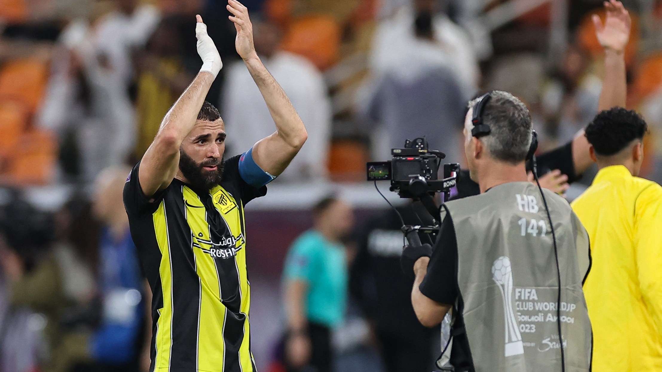Ittihad's French forward Karim Benzema (L) applauses at the end of the FIFA Club World Cup first round football match between Al-Ittihad and Auckland City at the King Abdullah Sports City stadium in Jeddah, on December 12. (AFP)