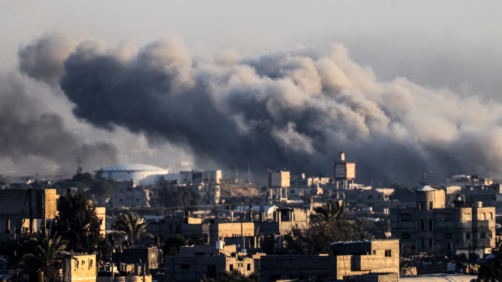 This photograph taken on 22 January 2024 from Rafah, shows smoke billowing during Israeli bombardment over Khan Yunis in the southern Gaza Strip (AFP)