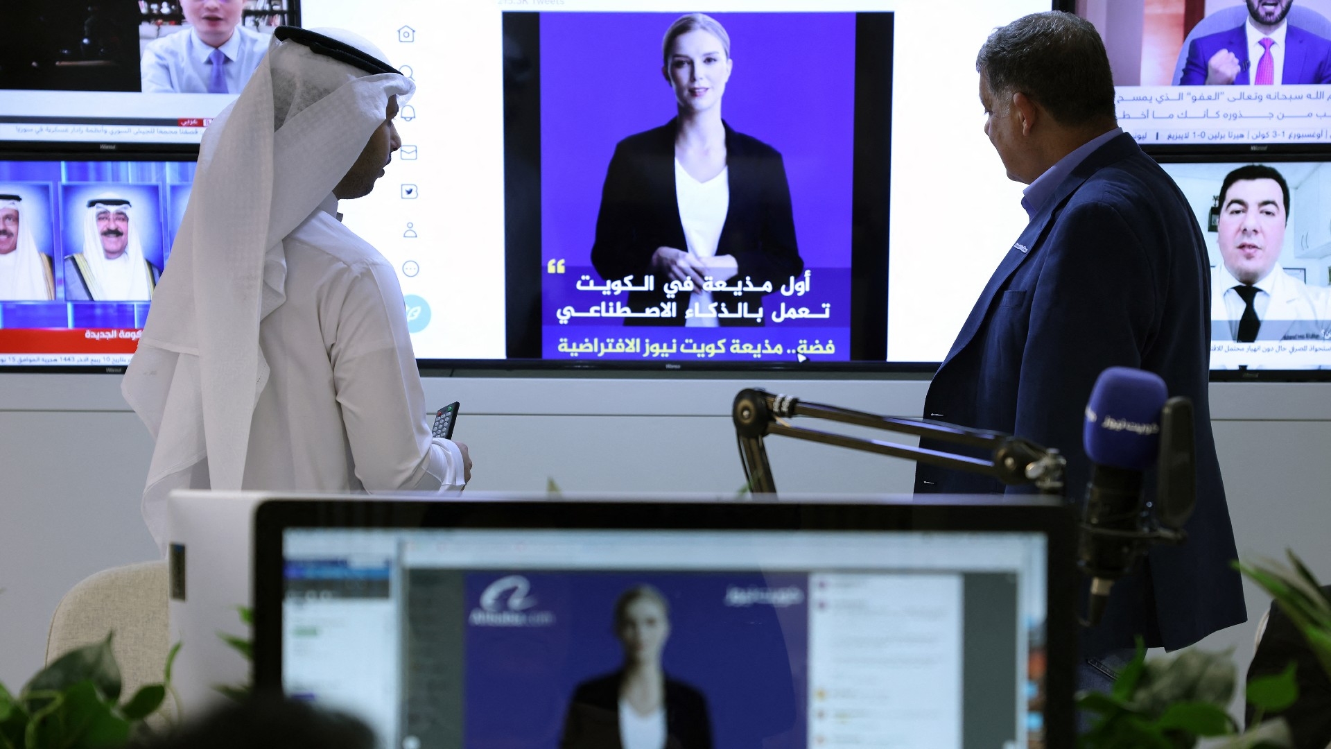 Journalists watch an introductory video by the 'artificial intelligence' anchor Fedha on the Twitter account of Kuwait News service, in Kuwait City on 9 April 2023 (AFP)