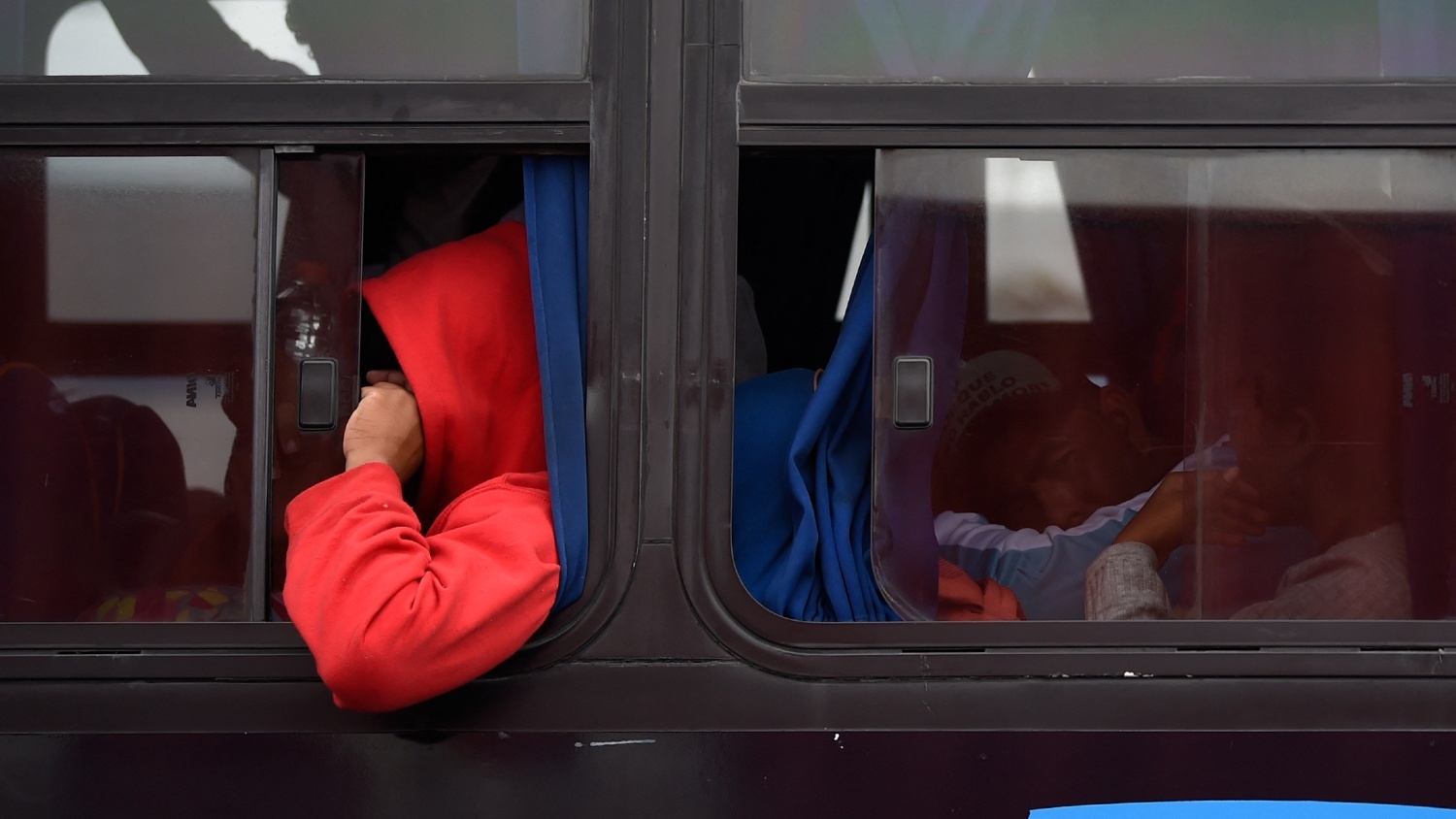 People moving towards the United States in hopes of a better life or to escape violence, travel in a bus on the outskirts of Mexico City as they continue their trek north, on 10 November 2018.