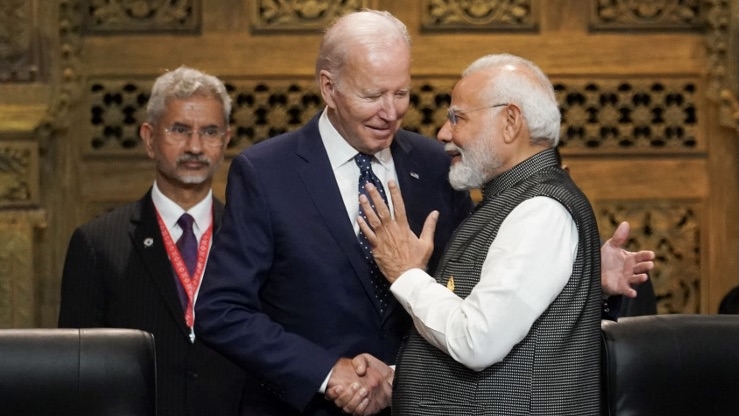 India's Prime Minister Narendra Modi (R) with US President Joe Biden (C) as India's Foreign Minister Subrahmanyam Jaishankar looks on at the G20 leaders' summit in Bali on 15 November 2022 (AFP)