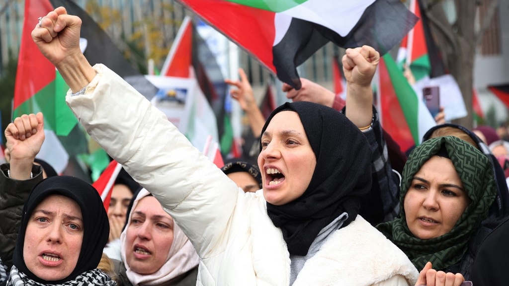 Protesters shout slogans during a demonstration in support of Palestinians near the US embassy in the Turkish capital, Ankara, on 10 December 2023 (Adem Altan/AFP)