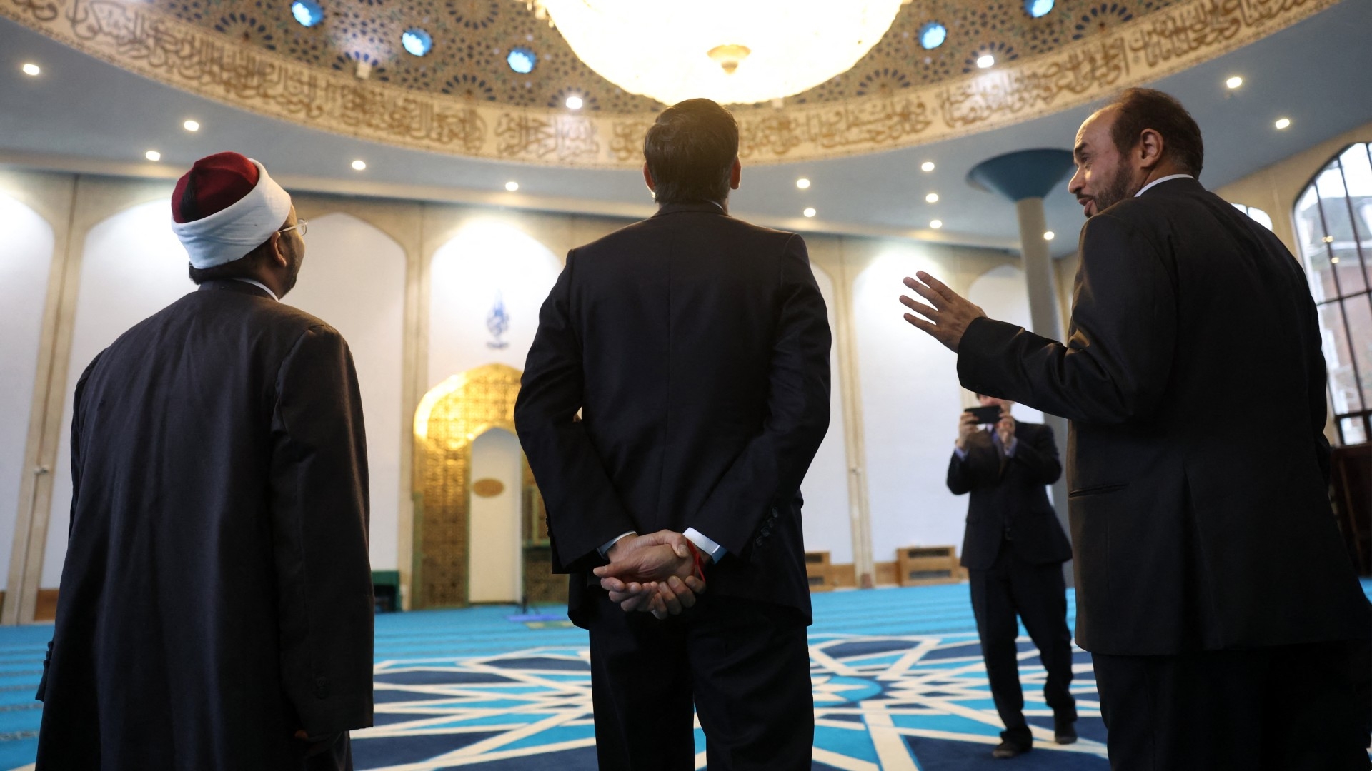 Britain's Prime Minister Rishi Sunak (C) is pictured in the prayer hall during a visit to the London Central Mosque on 11 March 2024 (AFP/Daniel Leal)