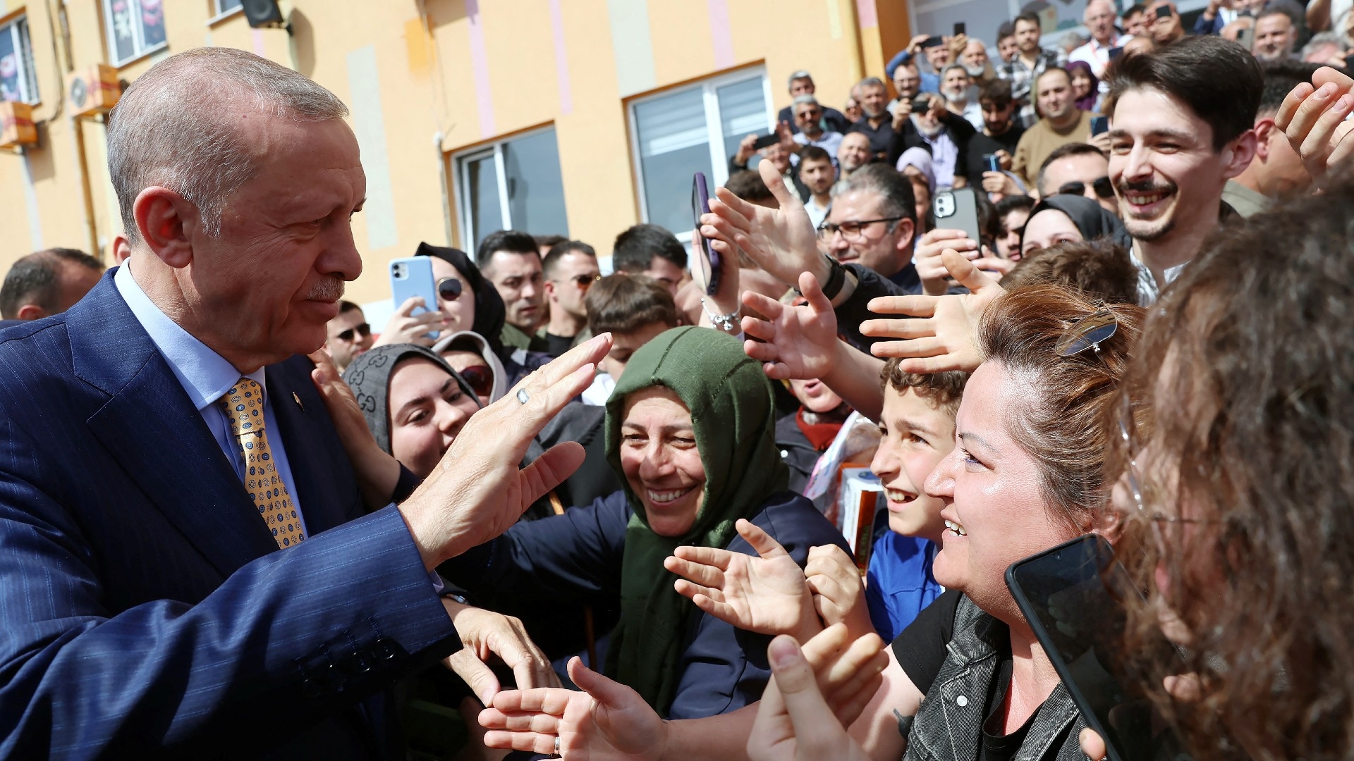 Turkish President Tayyip Erdogan greets his supporters as he leaves a polling station during the local elections in Istanbul, Turkey March 31, 2024. Murat Kulu/PPO/Handout via REUTERS