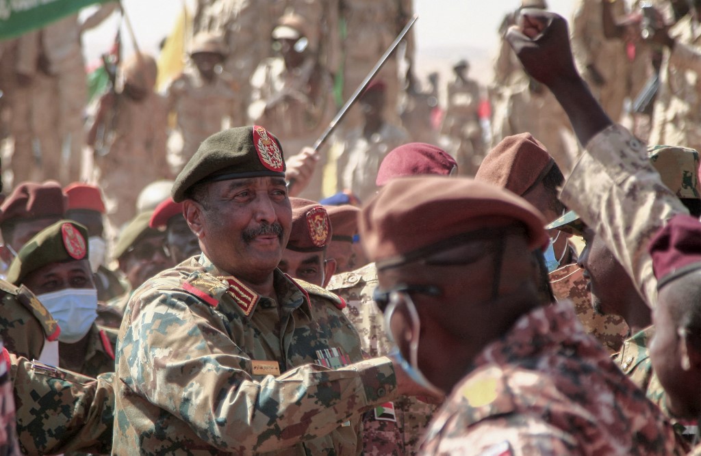 Sudan's top general Abdel Fattah al-Burhan greets soldiers as he attends the conclusion of a military exercise in the Maaqil area in the northern Nile River State, on December 8, 2021. Ebrahim HAMID / AFP