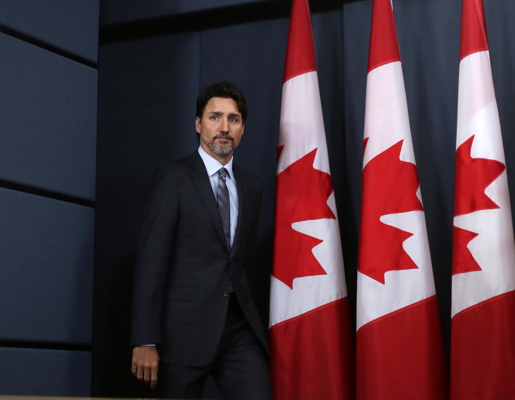 Canadian Prime Minister Justin Trudeau arrives to speak at a news conference in Ottawa on 11 January (AFP)