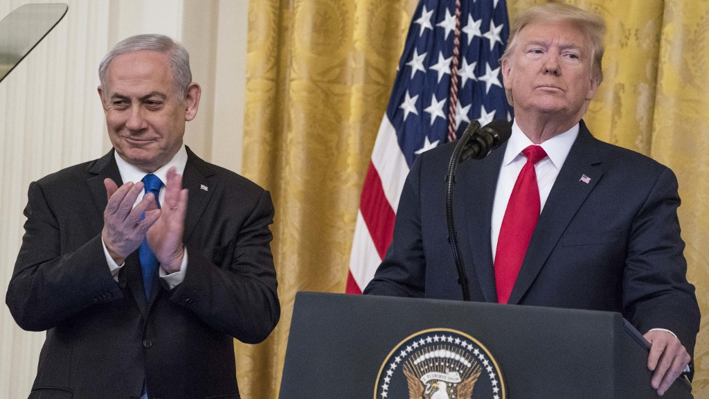 US President Donald Trump and Israeli Prime Minister Benjamin Netanyahu speak about Trump’s Israel-Palestine strategy on 28 January 2020 (Sarah Silbiger/Getty Images/AFP)